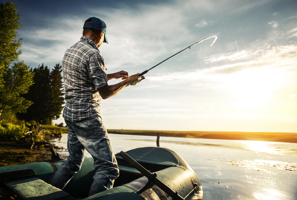 Mature,Man,Fishing,From,The,Boat,On,The,Pond,At