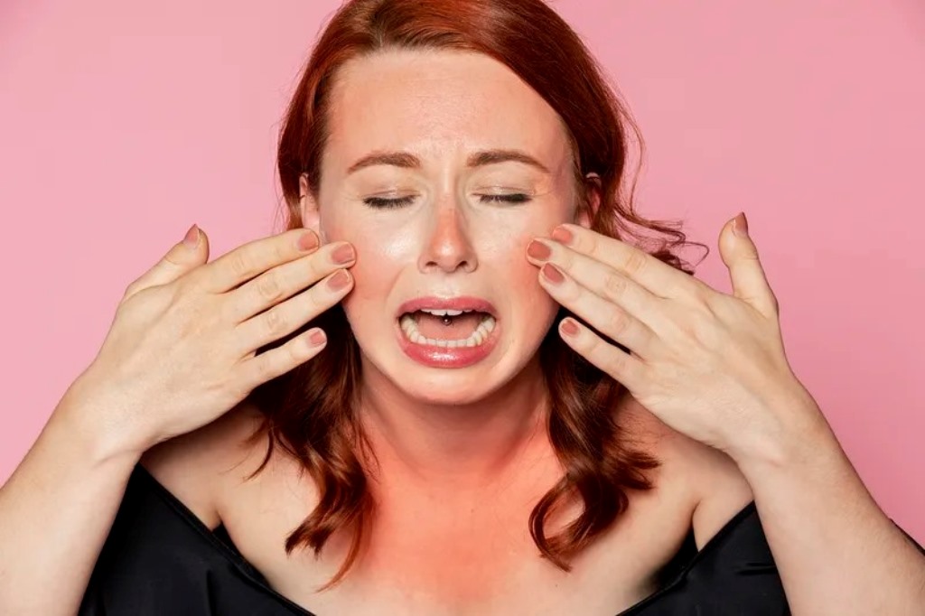 Woman crying over sunbunt skin